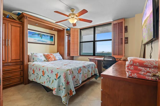 a bedroom with bed and a large window