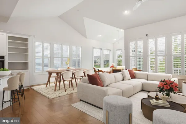 a living room with fireplace furniture and a large window