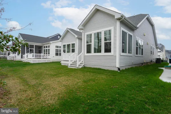 a view of a house with a wooden deck