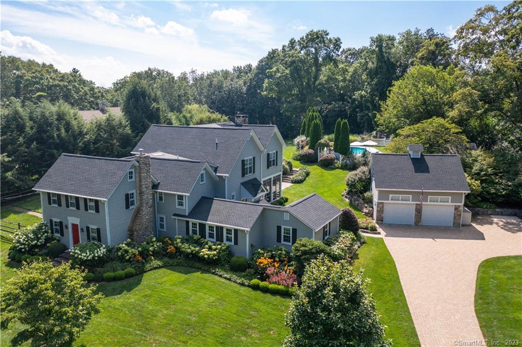 a aerial view of a house with swimming pool and a yard