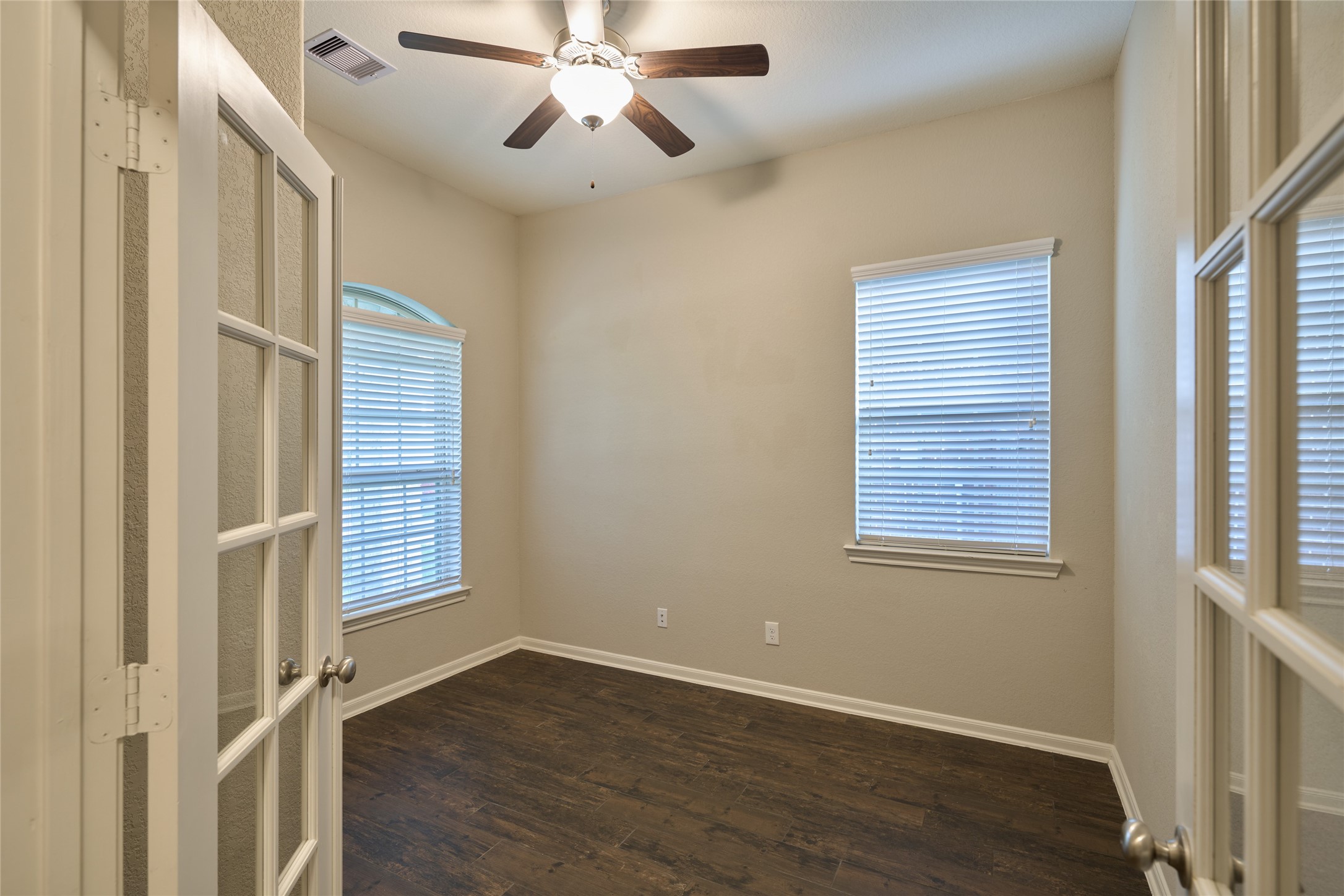 116 Fox Trail Road Montgomery, TX 77316 - Photo 6 of 50 The office/study/4th bedroom features wood-like tile flooring. The French doors add elegance and allow natural light to flow in.