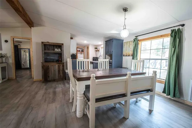 a living room with furniture a flat screen tv and wooden floor