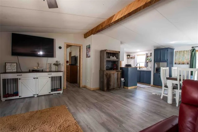 a kitchen with stainless steel appliances kitchen island granite countertop a refrigerator a stove a microwave oven a sink with island and chairs