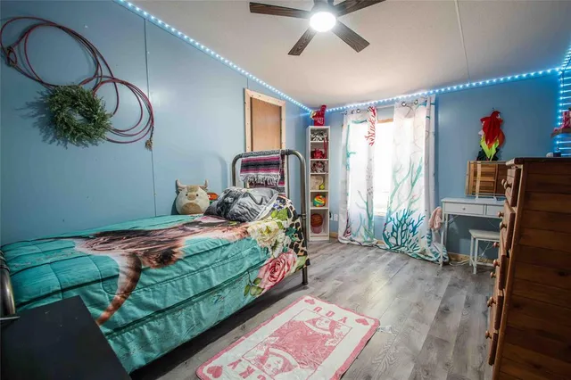 a bedroom with bed and a chandelier