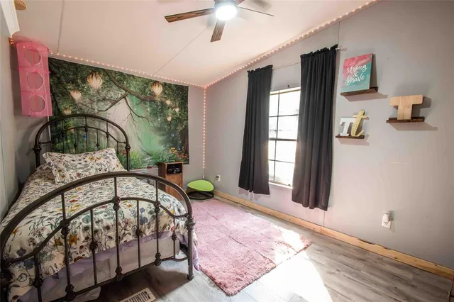 a view of a bedroom with a bed and large windows