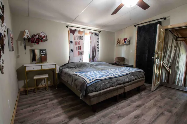 a bedroom with a bed dresser and a window