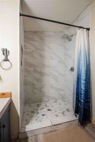 a bathroom with a shower and a sink