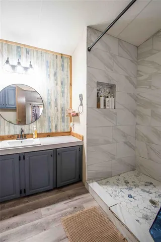 a bathroom with a tub sink and mirror