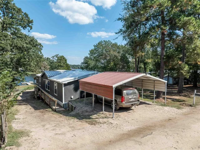a patio with a table and chairs under an umbrella