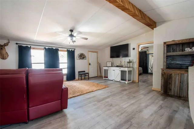 a living room with furniture and flat screen tv