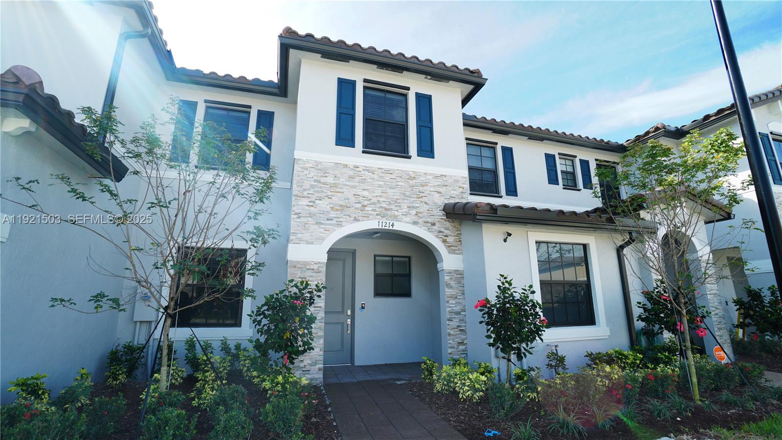 11214 Southwest 249th Street Homestead, FL 33032 - Photo 1 of 16 front view of a house with potted plants