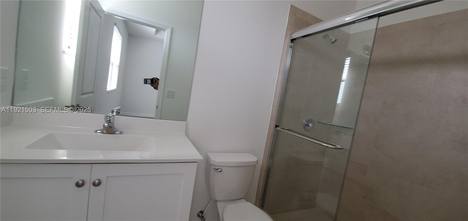 11214 Southwest 249th Street Homestead, FL 33032 - Photo 11 of 16 a bathroom with a sink a toilet and a mirror