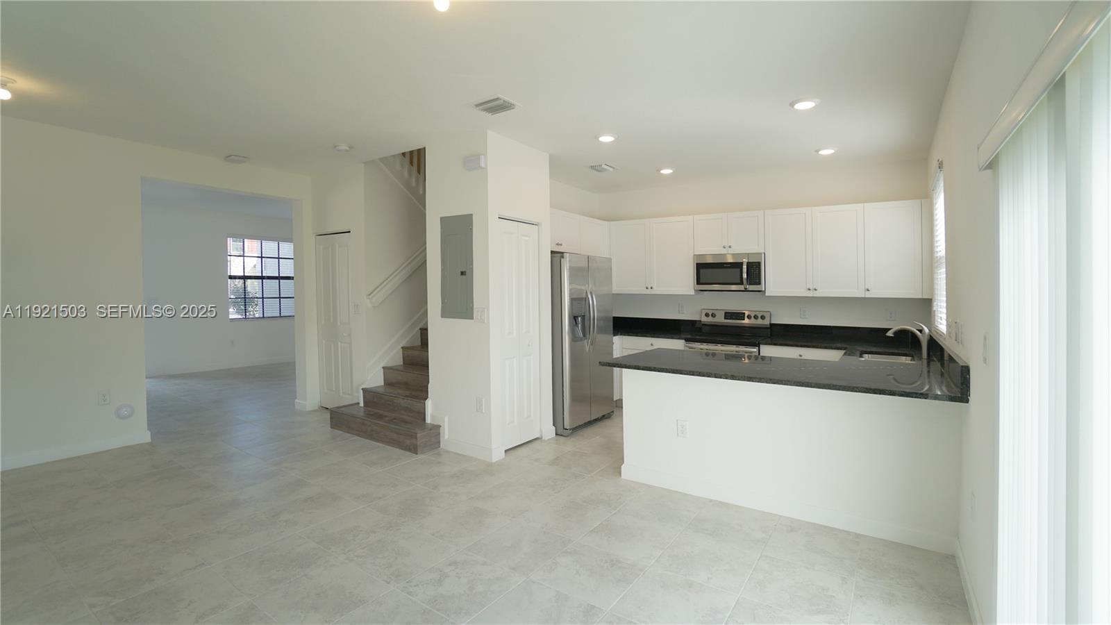 11214 Southwest 249th Street Homestead, FL 33032 - Photo 2 of 16 a kitchen with stainless steel appliances granite countertop a refrigerator and a stove top oven