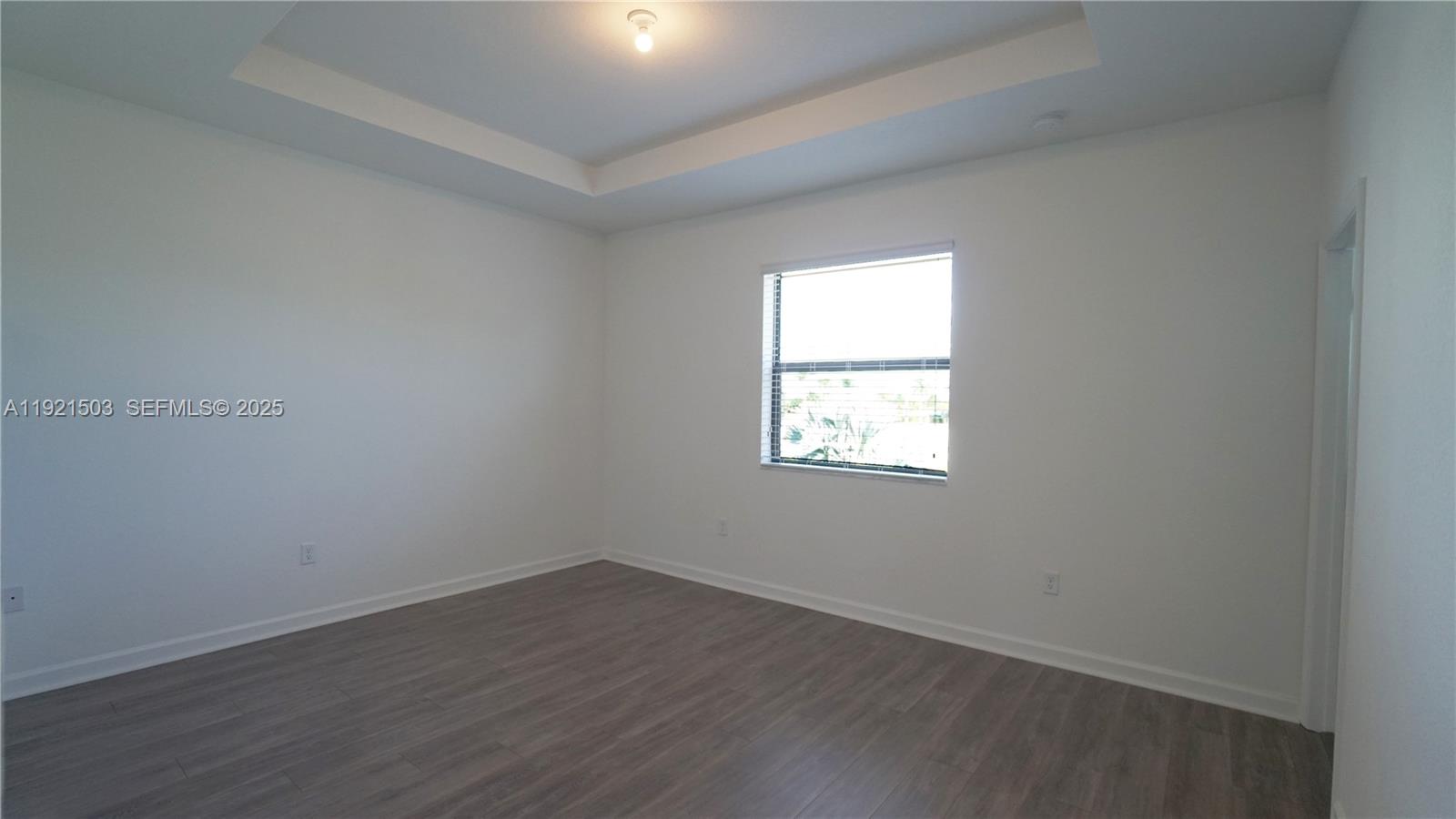 11214 Southwest 249th Street Homestead, FL 33032 - Photo 9 of 16 an empty room with wooden floor and windows