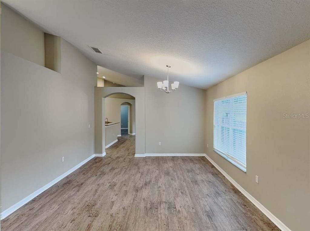 1805 Concord Drive Apopka, FL 32703 - Photo 3 of 12 a view of a big room with wooden floor and window