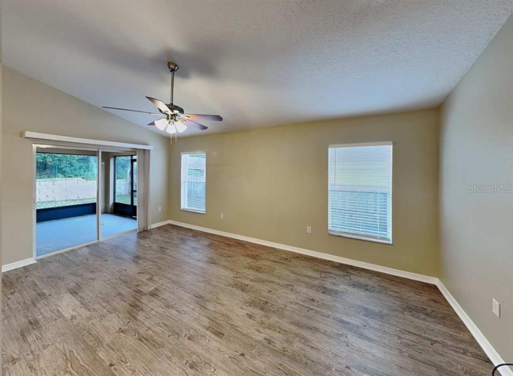 1805 Concord Drive Apopka, FL 32703 - Photo 4 of 12 a view of an empty room with window and wooden floor