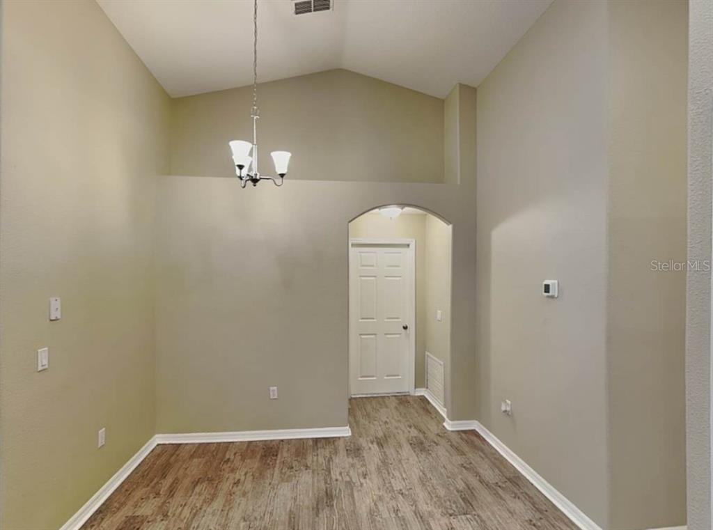 1805 Concord Drive Apopka, FL 32703 - Photo 6 of 12 an empty room with chandelier fan
