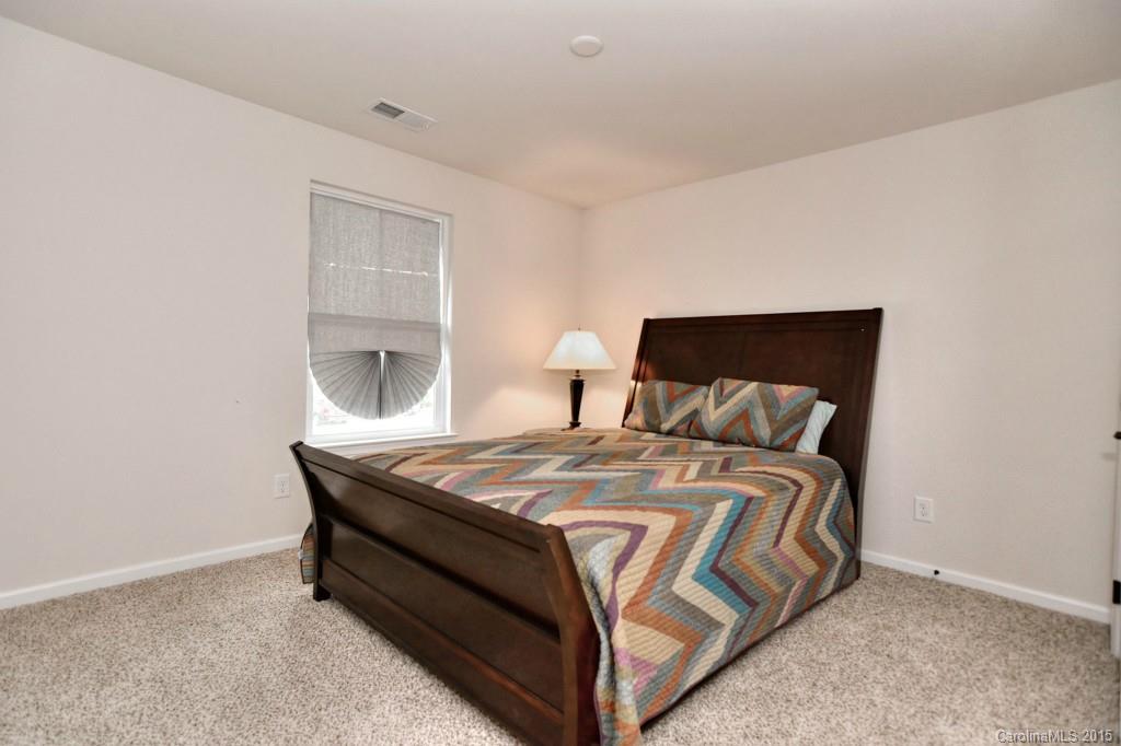 1605 Ridgehaven Road Waxhaw, NC 28173 - Photo 20 of 24 a bed sitting in a bedroom next to a window