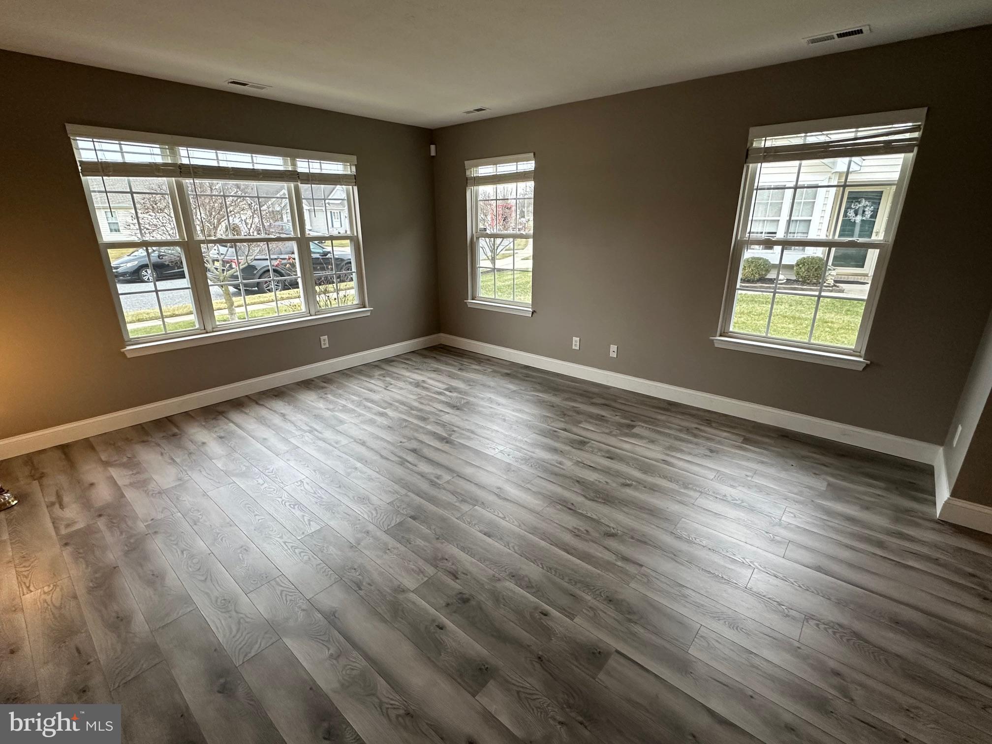 48 Maple Leaf Circle Sewell, NJ 08080 - Photo 5 of 23 a view of an empty room with wooden floor and windows