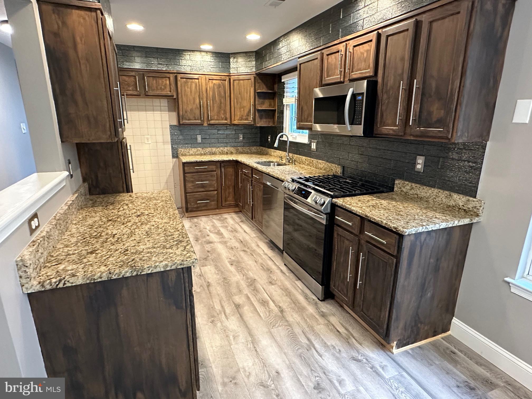 48 Maple Leaf Circle Sewell, NJ 08080 - Photo 7 of 23 a kitchen with stainless steel appliances granite countertop a stove top oven a sink dishwasher and a refrigerator
