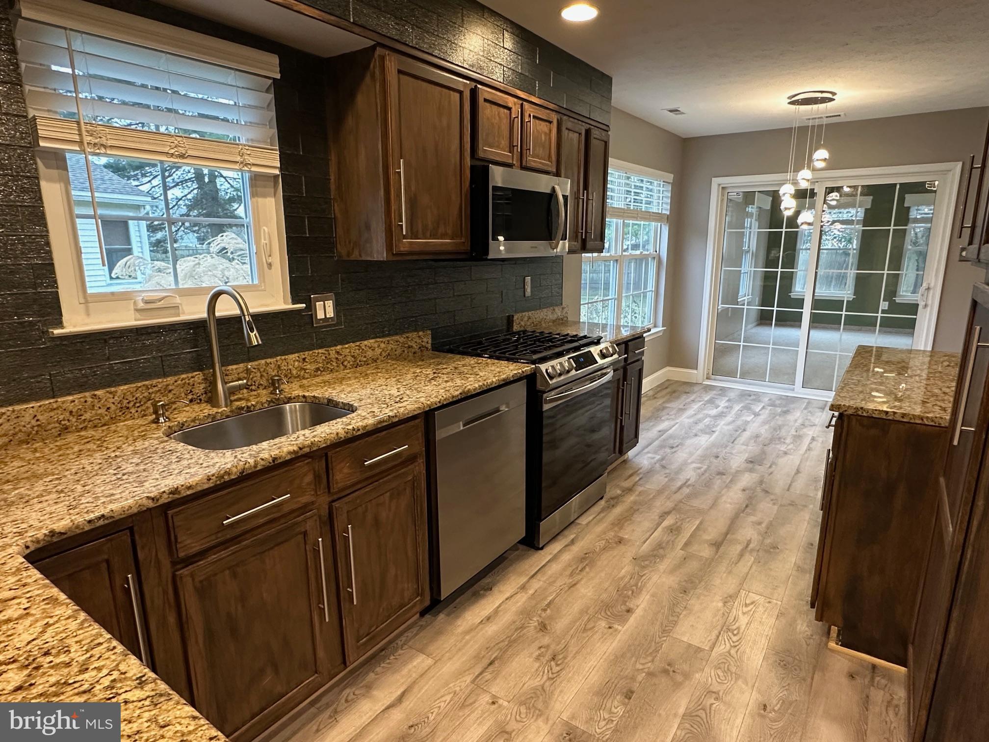 48 Maple Leaf Circle Sewell, NJ 08080 - Photo 8 of 23 a kitchen with granite countertop a sink stove and refrigerator