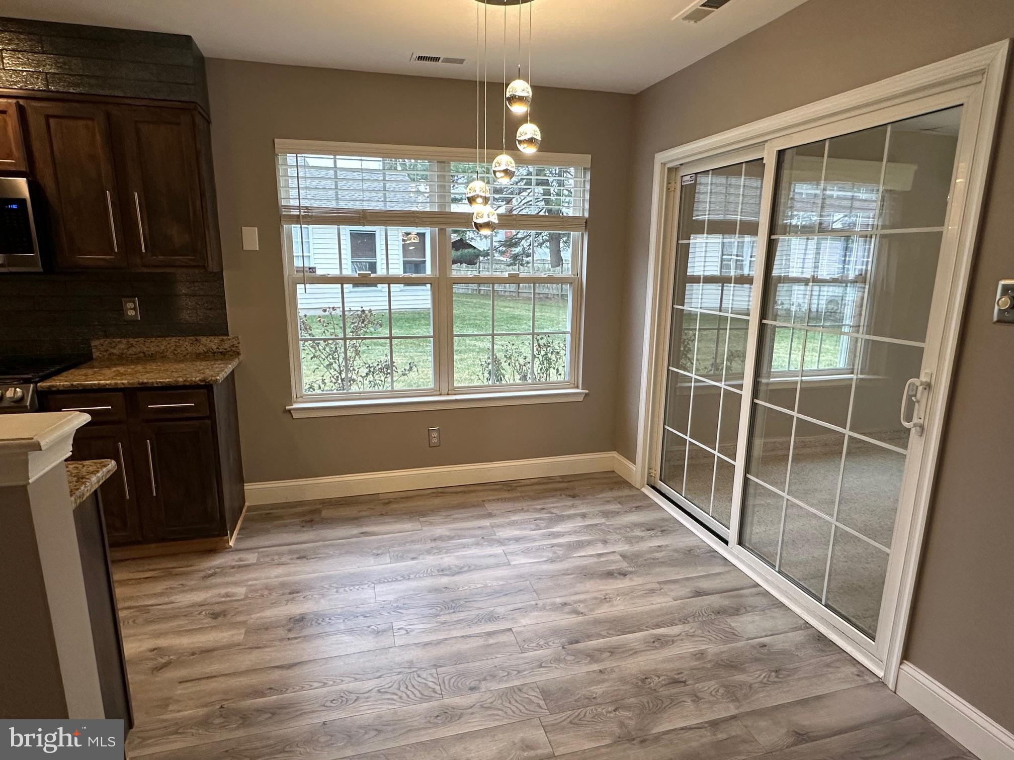 48 Maple Leaf Circle Sewell, NJ 08080 - Photo 9 of 23 a view of an empty room with window and wooden floor