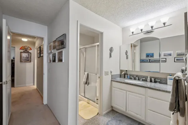 a spacious bathroom with a shower and a mirror