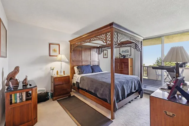 a spacious bedroom with a bed and a table