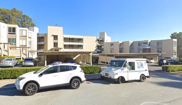 a car parked in front of a white house