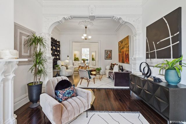 a living room with furniture and a potted plant