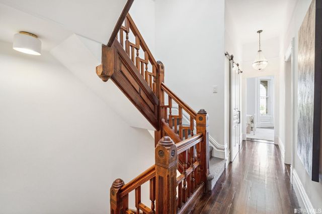 a view of hall way with furniture and a window