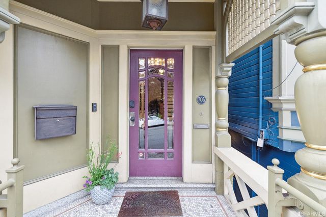 a living room with furniture a potted plant and a fireplace