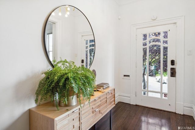 a living room with furniture a chandelier and a rug