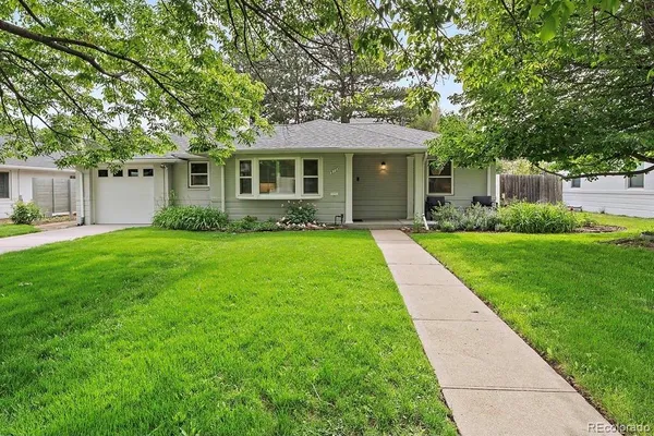 a front view of house with yard and green space