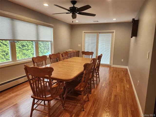 a view of a dining room with furniture window and wooden floor