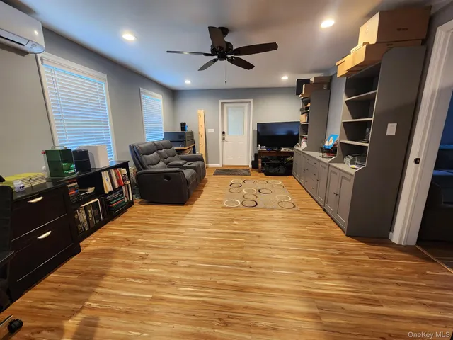 a large kitchen with stainless steel appliances kitchen island granite countertop a refrigerator a stove and a sink with wooden floor