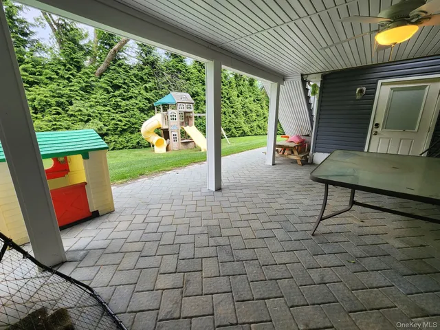 a view of a porch with chairs and backyard