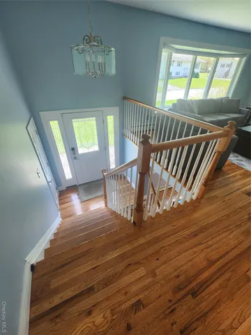 a view of an entryway with wooden floor