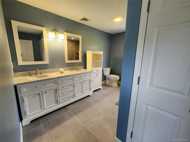 a bathroom with shower sink and mirror