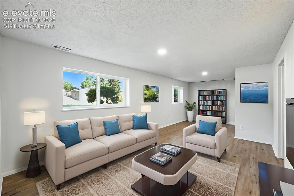 7033 Sequoyah Way Colorado Springs, CO 80915 - Photo 6 of 20 a living room with furniture and a lamp