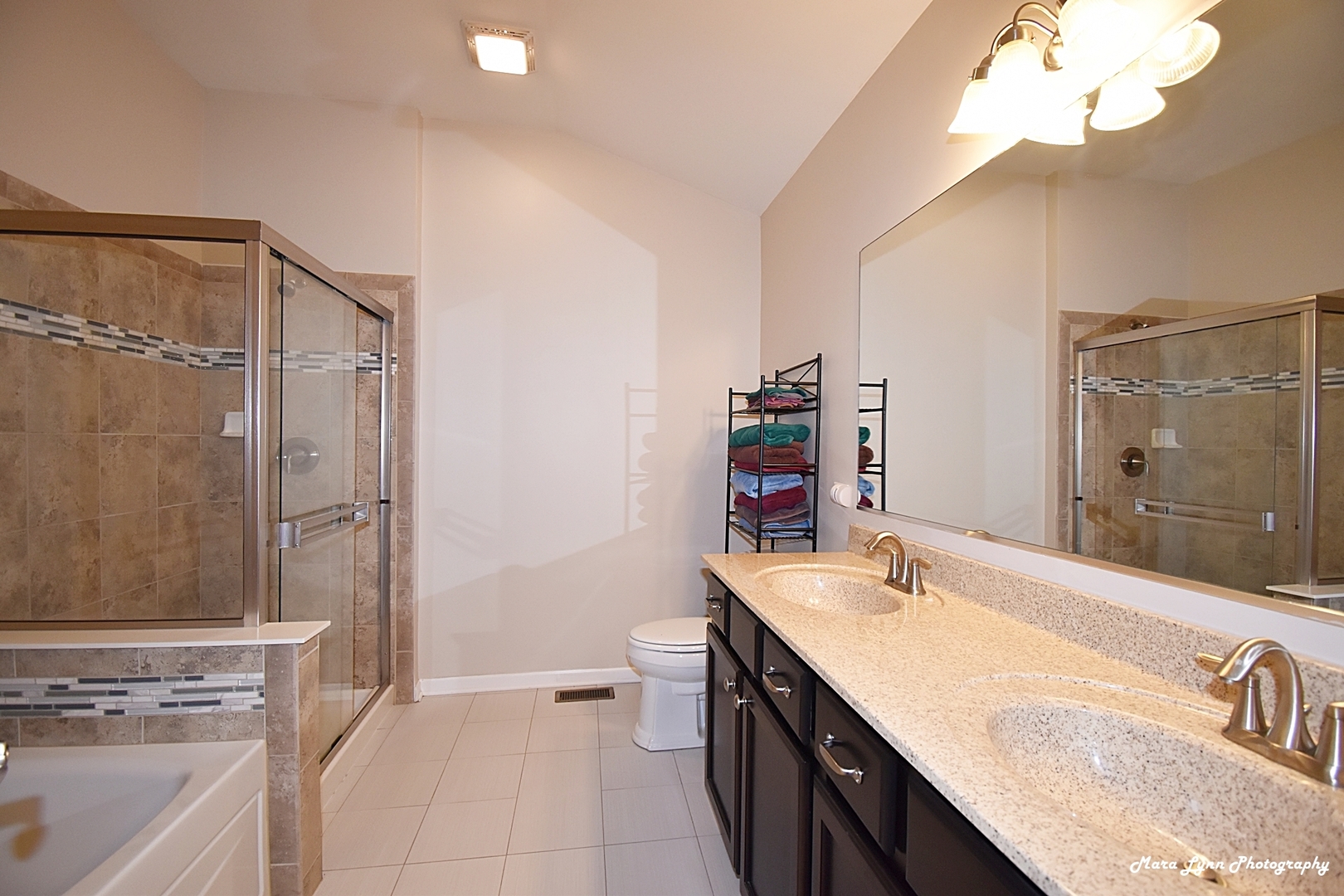 2872 Church Road Aurora, IL 60502 - Photo 29 of 38 a bathroom with a granite countertop sink a mirror and a bathtub