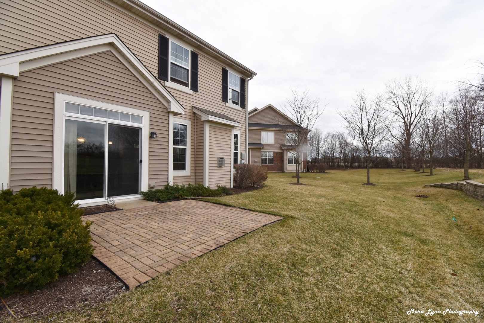 2872 Church Road Aurora, IL 60502 - Photo 8 of 38 a view of a white house with a yard and plants