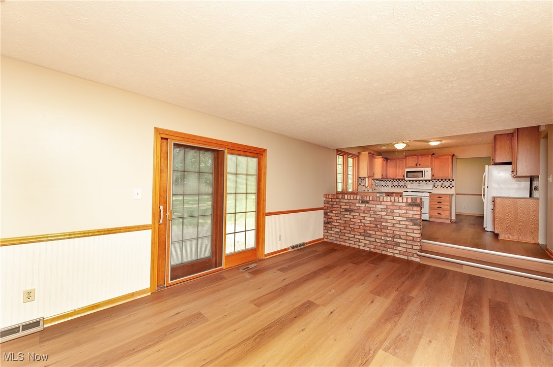 27680 Dunford Road Westlake, OH 44145 - Photo 10 of 31 Unfurnished living room with light wood-style floors and a textured ceiling