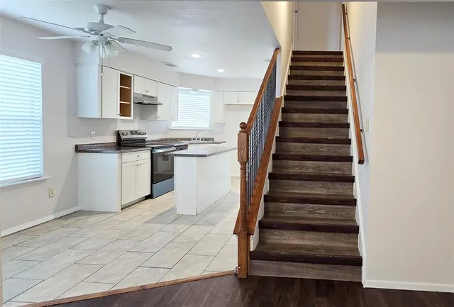 a view of kitchen with sink microwave and stove