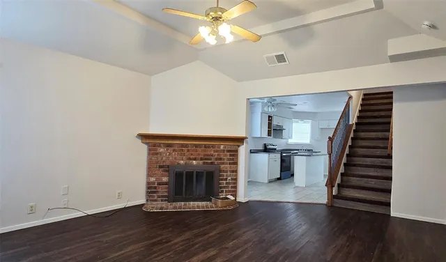 a living room with wooden floors and a fireplace