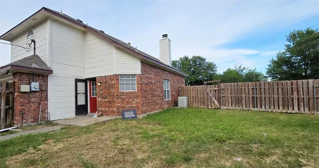 a view of a backyard with wooden fence