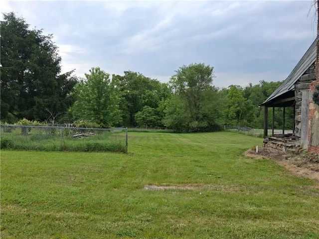 a view of a house with a backyard