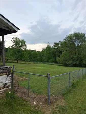 a view of house with backyard