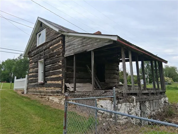 a view of a house with a yard and sitting area