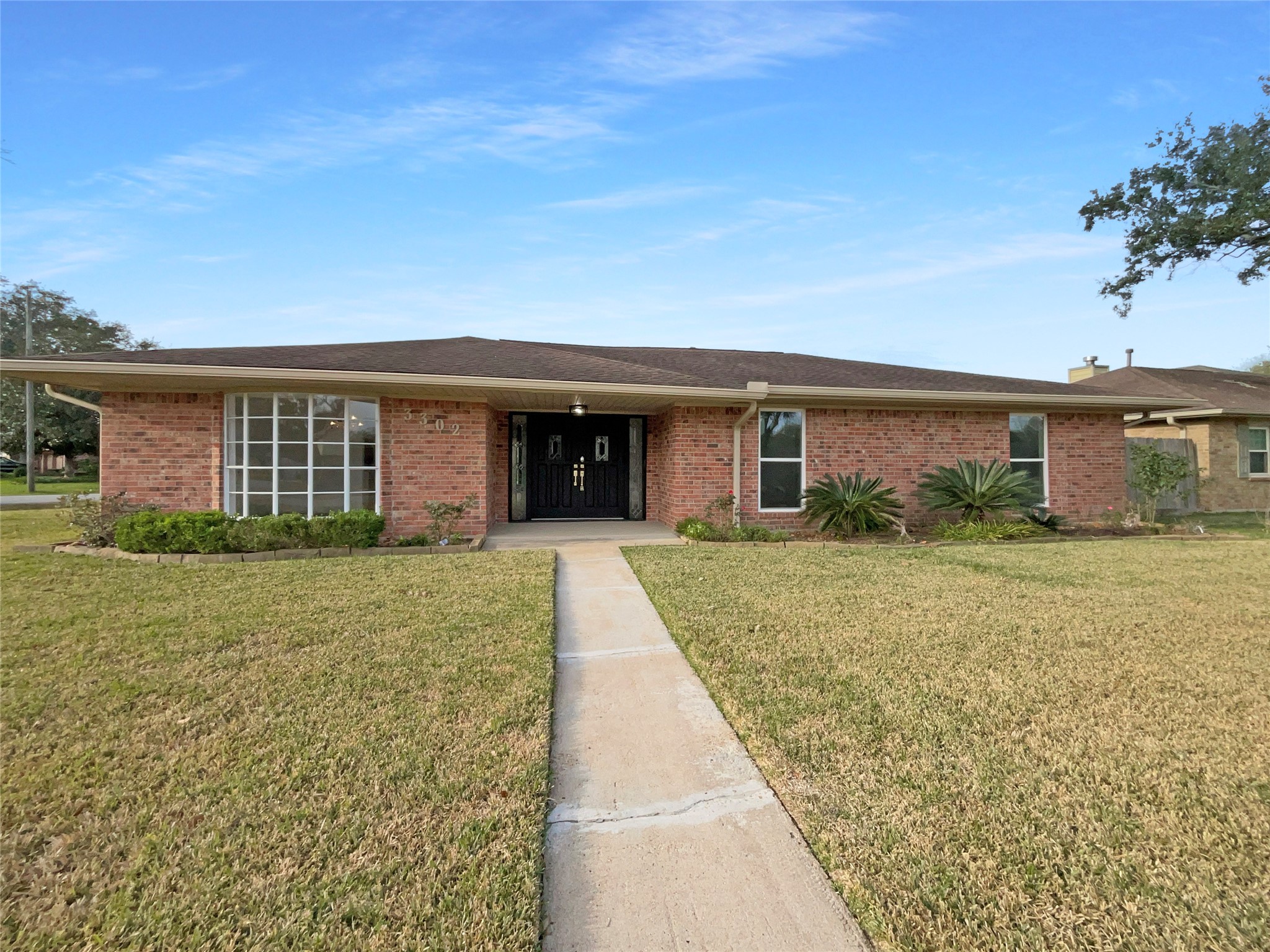 3302 Windsor Drive Pearland, TX 77581 - Photo 1 of 21 front view of a house with a yard